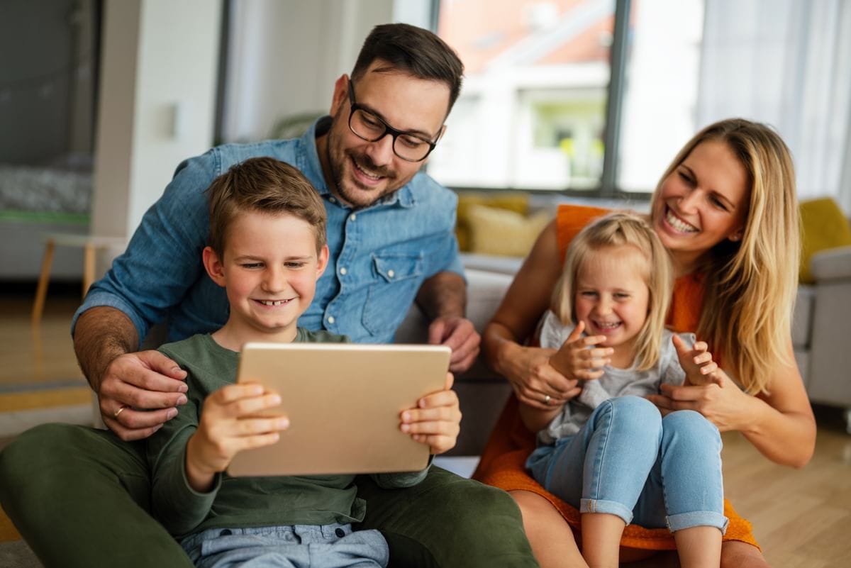 Family looking at a tablet together
