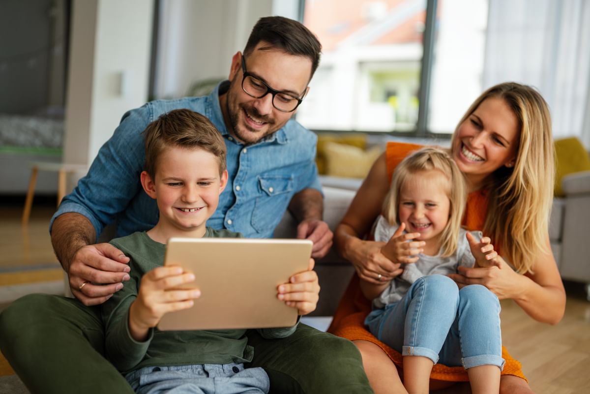 Family looking at a tablet together